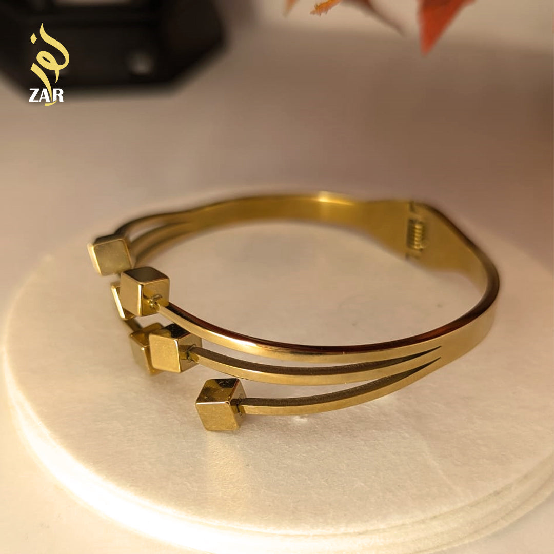 Gold bracelet on a light background 