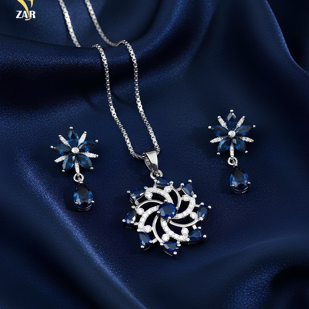 Jewelry set with necklace and earrings on a blue satin background, featuring the ZAR brand.